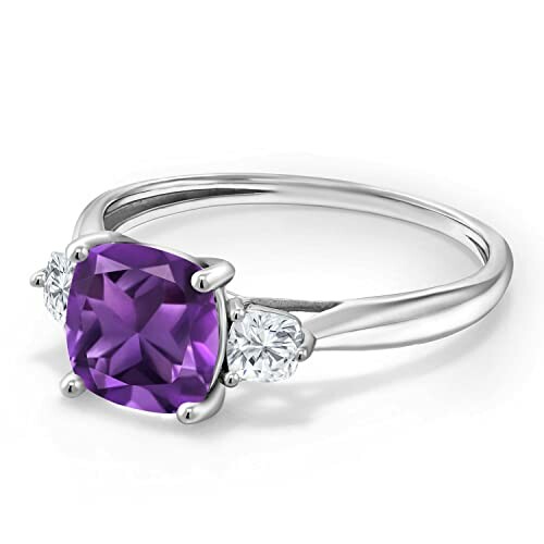 Silver ring with a purple amethyst and two diamonds.