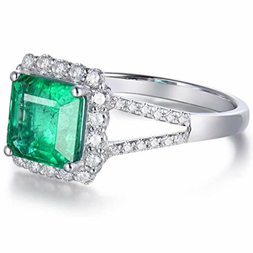 Emerald cut emerald ring with diamond accents.