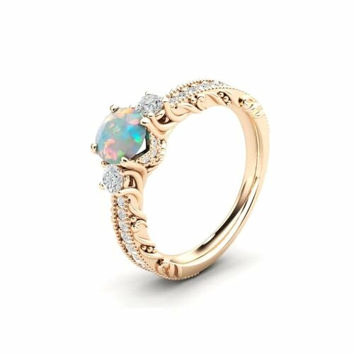 Elegant opal engagement ring with intricate gold band and diamond accents.