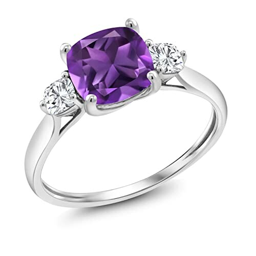 Silver ring with a purple gemstone and two diamonds.